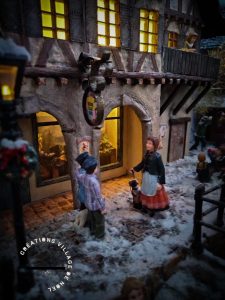 créations village de Noël La conversation des enfants